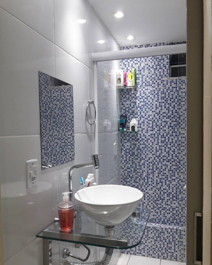 banheiro com cerâmica geométrica no piso e paredes lisas